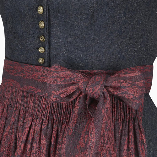 Close-up of a dark blue garment with gold buttons and a red patterned belt.