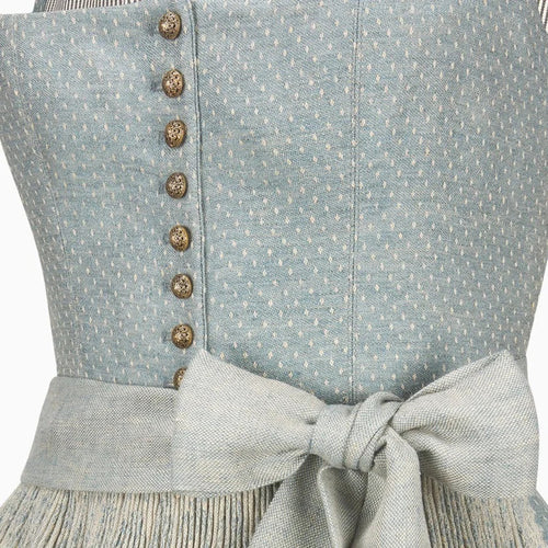 Close-up of a light blue dress with buttons and a bow detail.