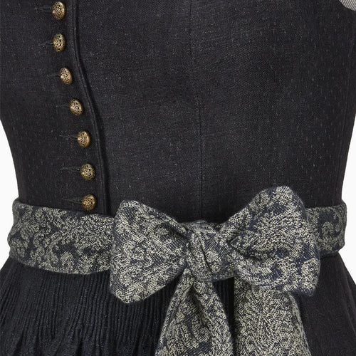 Black dress with gold buttons and a patterned belt on a plain background