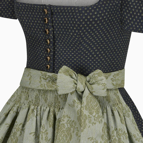 Close-up of a dress with a patterned top and floral skirt on a white background