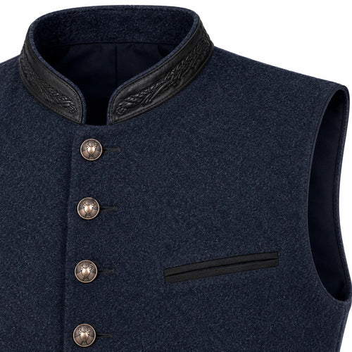 Close-up of a dark navy wool vest with a high collar, black leather-like trim, decorative buttons, and a welt pocket on a white background.