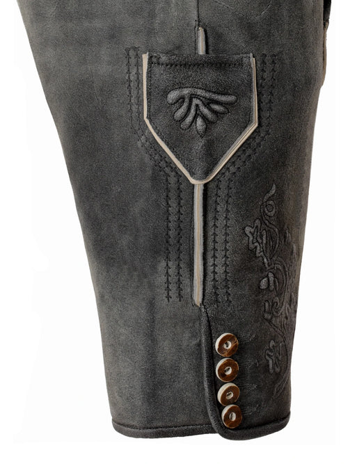 Close-up of gray leather pants with decorative stitching and buttons on a white background