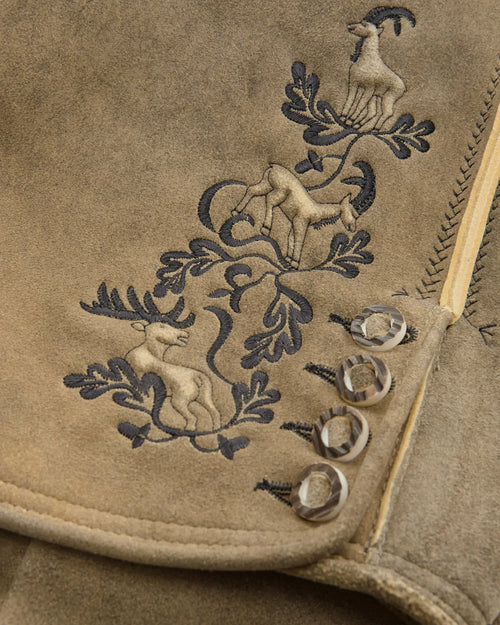 Embroidered design on a beige fabric with animals and leaves.