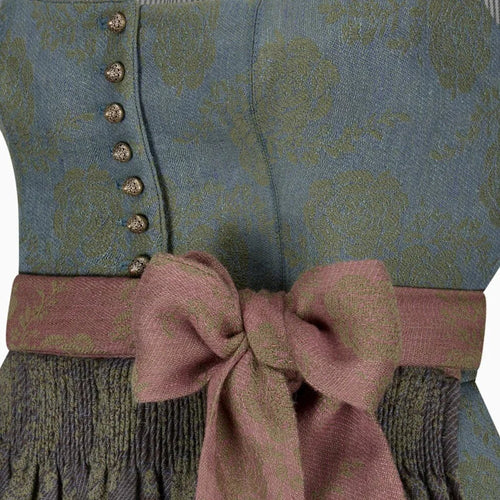 Close-up of a patterned garment with a pink bow and buttons.