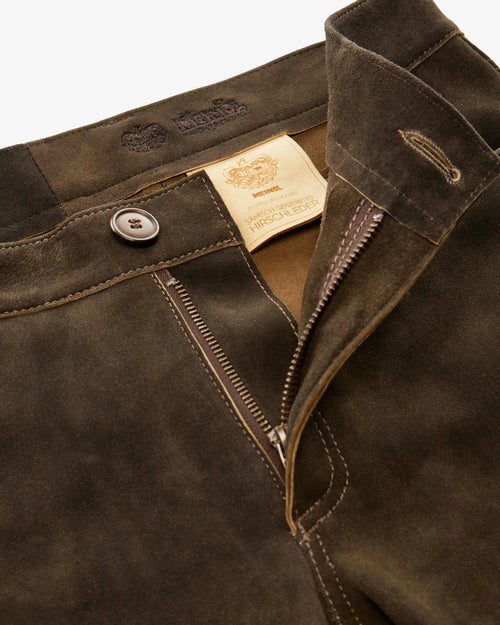 Close-up of a brown jacket with a brand label on a white background