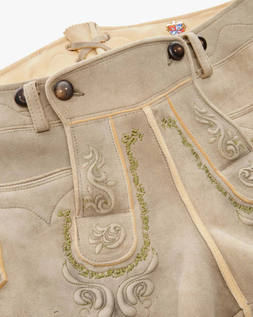 Traditional German lederhosen with embroidery on a white background